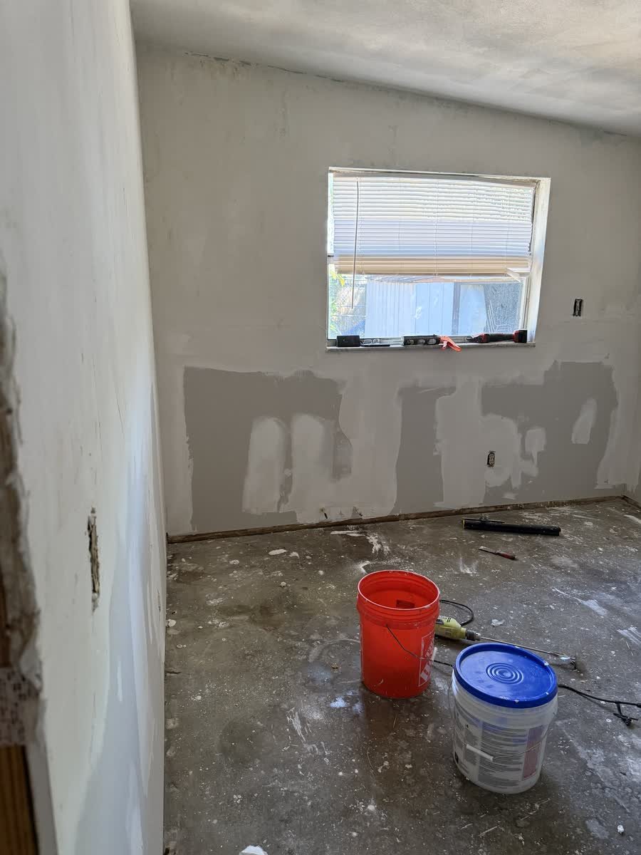 New drywall hung and patched under the window