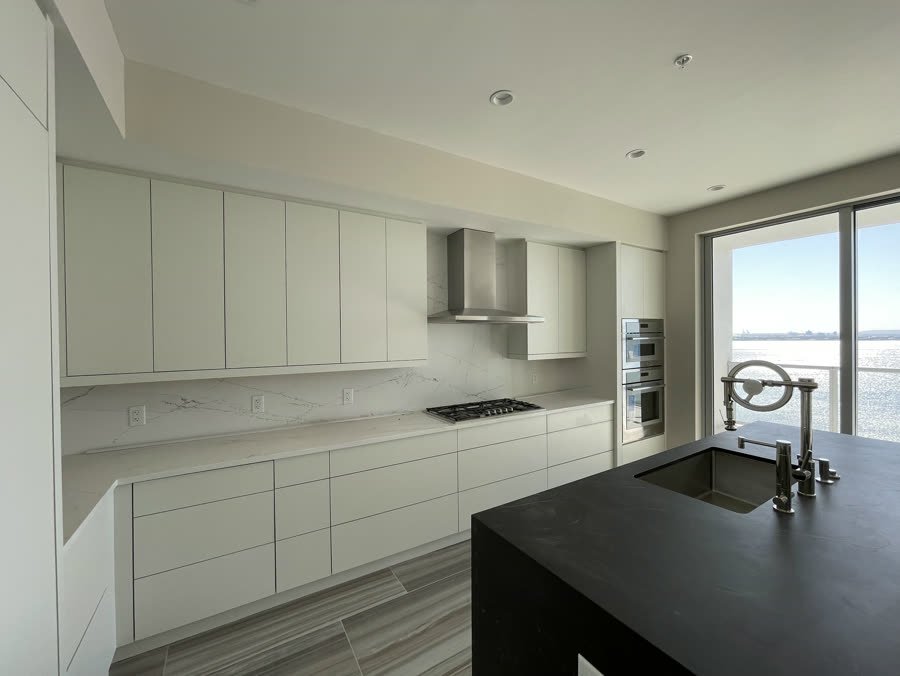 Open plan living space with a remodeled kitchen and water views